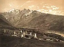 Traditional villages with mountains in background.