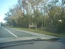 Northbound SR 121 as it approaches a sign welcoming motorists to Worthington Springs.