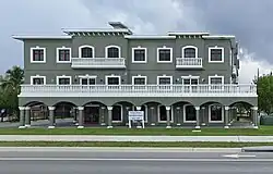 A grey building with white accents and a sign that says "Future Home: Fort Myers Beach Town Hall"