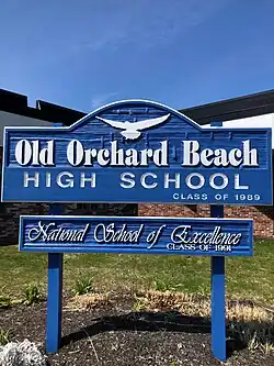 Exterior of OOBHS, showing blue sign that says OLD ORCHARD BEACH HIGH SCHOOL