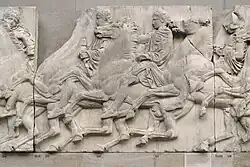 A Greek sculpture showing cavalrymen riding right to left in procession