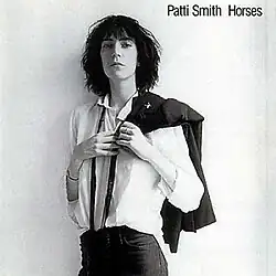 The album cover features a black-and-white photograph of Patti Smith slinging a jacket over her shoulder.