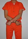 Inmate in belly chain with the arms crossed (high security restraint)