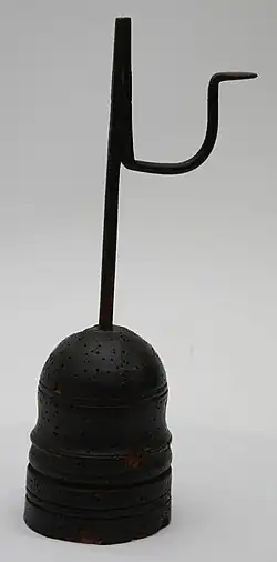 Rushlight with (pest) holes in base