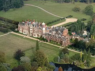aerial view of large red-brick house in landscape