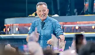 A man performing on stage holding a microphone