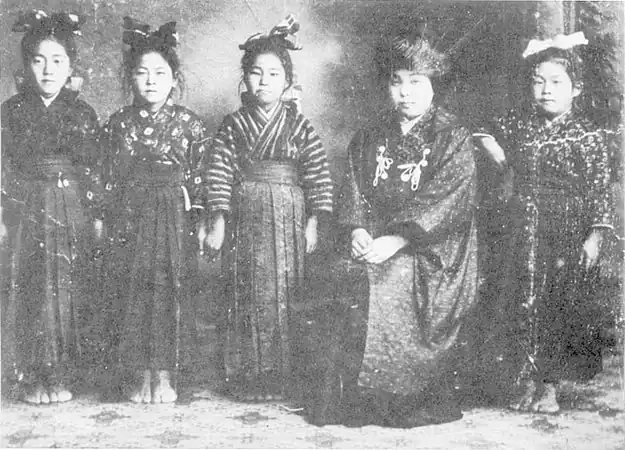 A schoolteacher wearing a hifu with white ties, 1912.