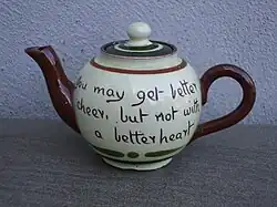 A round earthenware teapot, inscribed 'You may get better cheer, but not with a better heart'