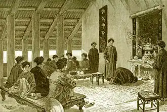 People in the Nguyễn dynasty with khăn vấn. The people in the back are sitting on a sập.