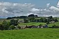 View of Ughill Farm with surrounding hills and fields