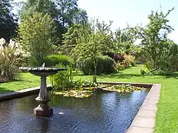 a rectangular pond within a walled garden