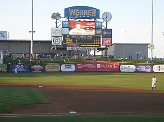 The red, white, and blue façade of a steel and concrete ballpark