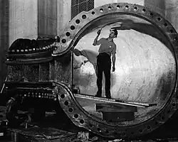 Worker inside a hydraulic turbine runner, c. 1938-1941