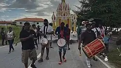 Yellow, Gold and Red Tadjah being moved on a road