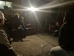 Ana Martinez de Luco plays guitar at the Earth Day 2023 celebration