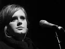 A black and white close up picture of a woman singing