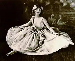 Black and white portrait photograph of a young woman in 1920s dance costume with ornate headpiece