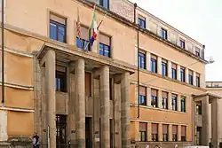 Large institutional building in Fascist-era architectural style.