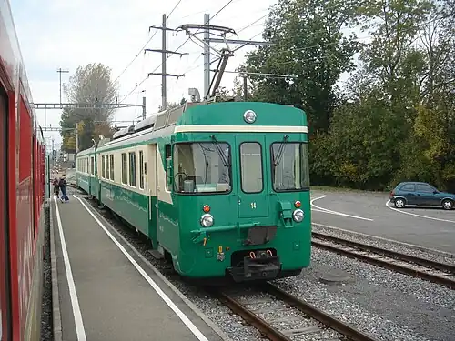 Green and white train at a station