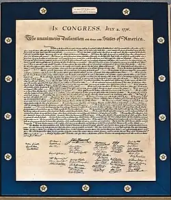 A plaque that contains a print of the original Declaration of Independence. The plaque is outlined by a blue frame, engraved with stars.