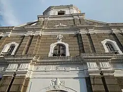 The church's façade showing its status as a basilica with the Papal Keys