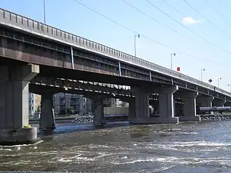 Two non-identical box girder bridges over rapids.