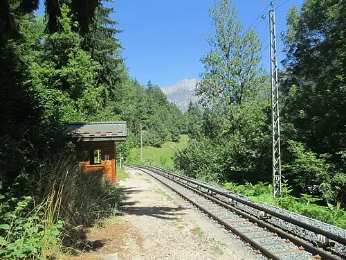 Shelter on side platform next to single-tracked railway line