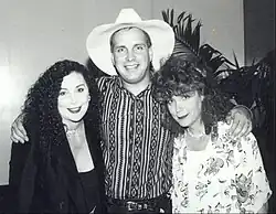 Singer Garth Brooks posing with two women