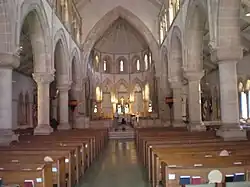 Interior of nave, with fans in pews