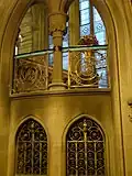 Gothic style ironwork, on the lower flight of the Main Staircase, Manchester Town Hall, with typical Waterhouse glass in the background
