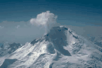 A snow-covered mountain, with a plume of steam and gas rising from the top