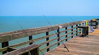 Myrtle Beach State Park's pier with fishing poles cast off the side