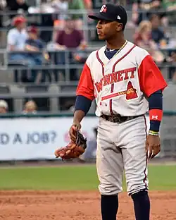 A baseball player in a gray uniform