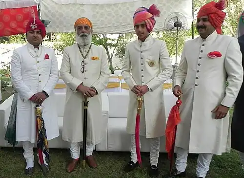 Achkan sherwani and churidar (lower body) worn by Arvind Singh Mewar and his kin during a Hindu wedding in Rajasthan, India.