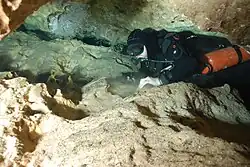 Sidemount diver in fairly tight space
