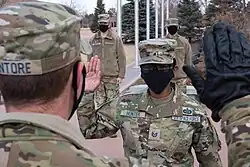 The OCP uniform with a patrol cap and air force rank insignia.