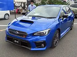 Subaru WRX S4 STI Sport, a high-performance variant of the Subaru WRX S4. This photo shows the front of the car, which is blue with a small "STI" emblem on the front grille.