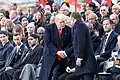 US President Donald Trump and French President Emmanuel Macron shaking hands in front of a crowd of world leaders