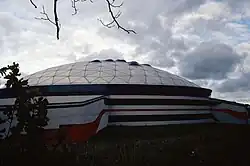 Exterior of a three-story building featuring a geodesic dome